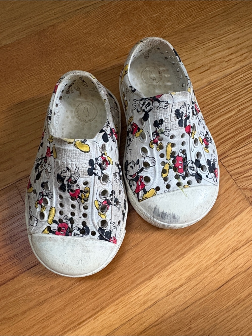 Native Shoes Kids Slip-On Sneakers in White with Red and Yellow Mickey Print